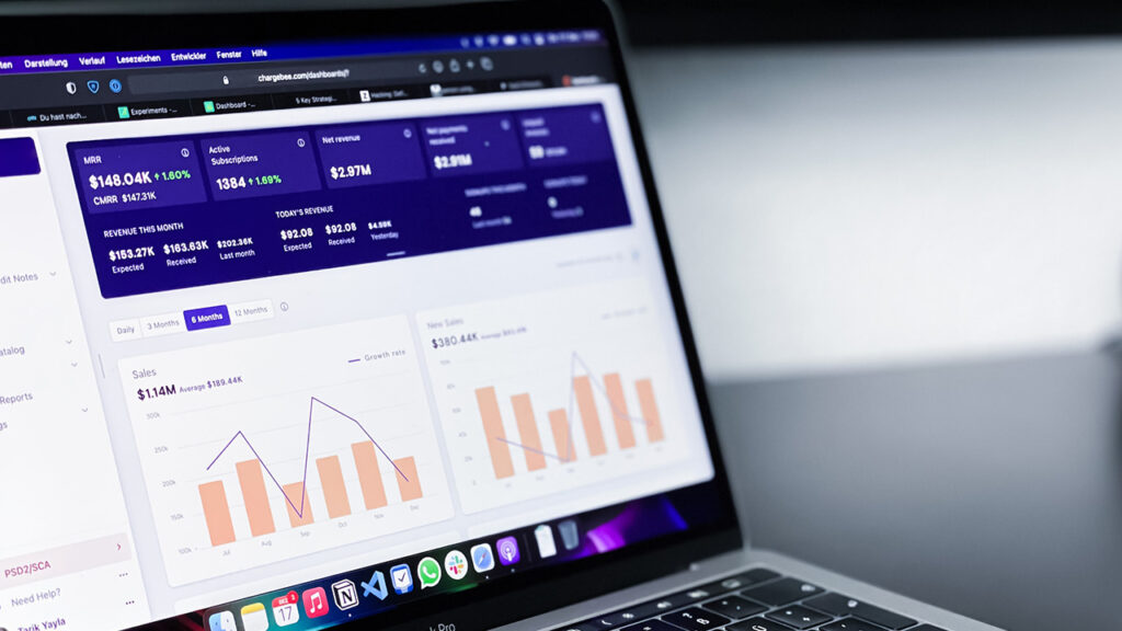 A laptop showing an analytics platform with data
